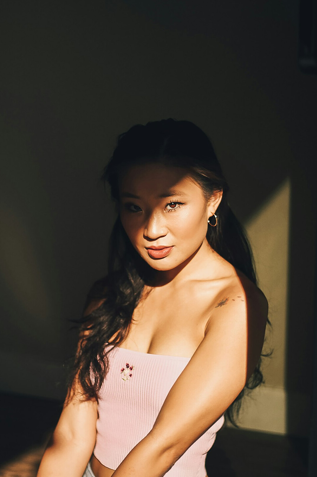 Studio portrait of an Asian woman smiling confidently