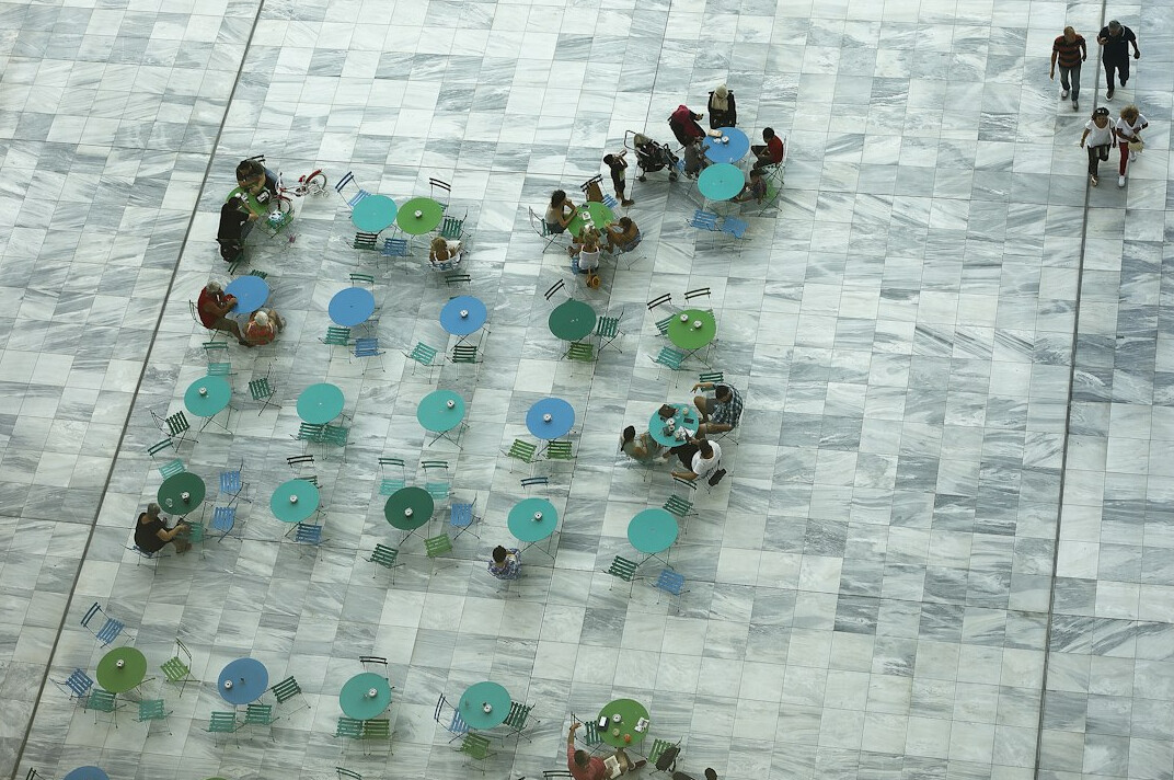 Overhead view of a team working together around a table with laptops